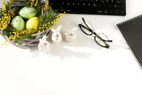Easter background. office table desk, workspace with laptop, easter bunny,  bouq Stock Photos