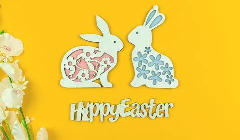 Easter background or postcard on a yellow background with text and bunny deco Stock Photos