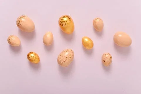 Easter background with painted eggs and sequins. Copy space. Flat lay, top vi Stock Photos