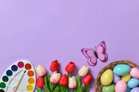 Easter background with painted eggs, paints and tulips. Copy space. Flat lay, Stock Photos