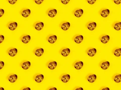 The easter background with the quail brown eggs pattern on the trendy yellow. 스톡 사진