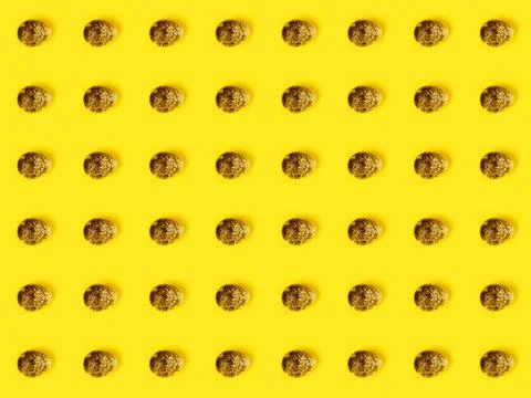 The easter background with the quail brown eggs pattern on the trendy yellow. 스톡 사진