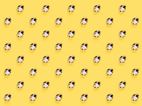 The easter background with the quail brown eggs pattern on the trendy yellow. 스톡 사진