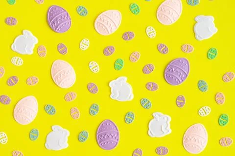 Easter background rabbits and eggs on yellow backgraund. Flat lay Stock Photos