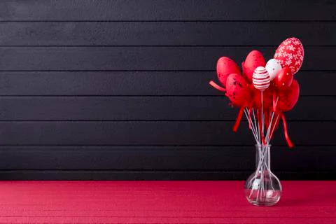 Easter background with red and white eggs on glass bottle Foto stock