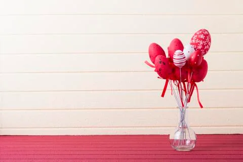Easter background with red and white eggs on glass bottle Stock Photos