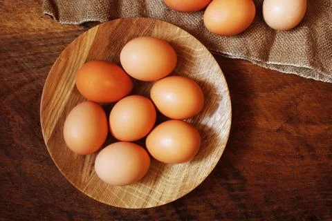 Easter background. Rustic wooden table with plate, egg, jute bag . Top view Stock Photos