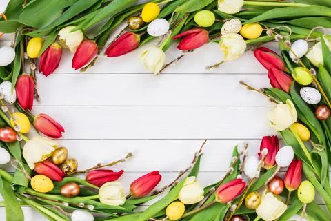 Easter background. Spring flowers and eggs on white background. Top view, copy Stock Photos