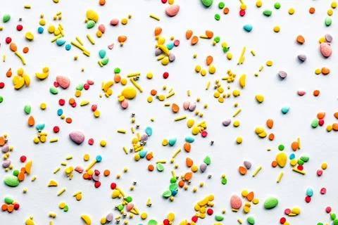 Easter background. Sprinkling with sugar balls and eggs, decoration for cake and Stock Photos