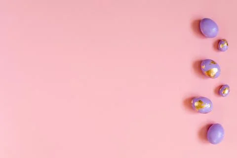 Easter background, violet, very peri eggs with golden foil on the pink Stock Photos
