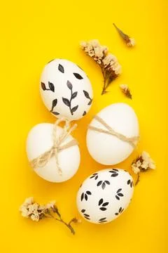 Easter background - white easter egg with flowers inside on yellow backgrou.. Stock Photos