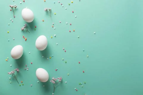 Easter background with white eggs on a blue background. Copy space. Flat lay Stock Photos
