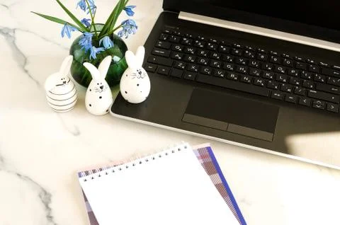 Easter background.Flat lay office table, workspace with laptop, Easter bunn Stock Photos