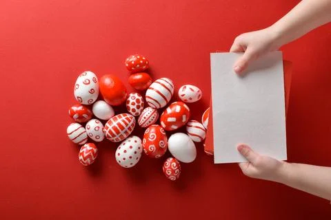 Easter backgrounds with a blank sheet of paper in the hands of a child and .. Stock Photos