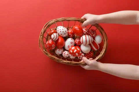 Easter backgrounds. The child's hands hold a basket with Easter red and white Stock Photos