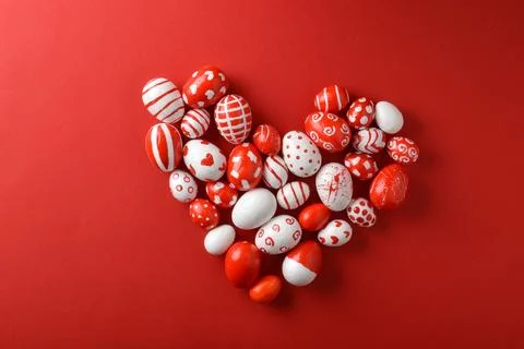 Easter backgrounds, a heart of Easter red and white eggs on a red background. Stock Photos