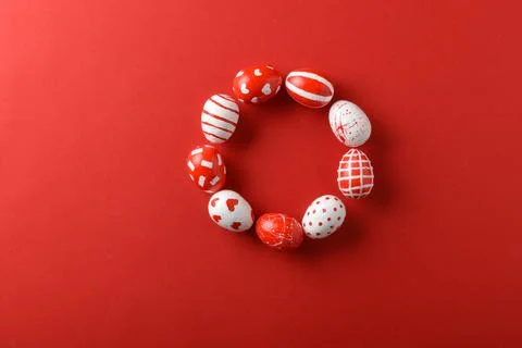 Easter backgrounds with a round frame of Easter red and white eggs on a bright Stock Photos