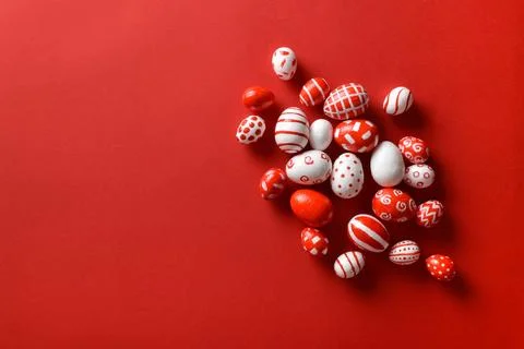 Easter backgrounds, scattered Easter red and white eggs on a bright red backg Stock Photos