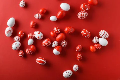 Easter backgrounds, scattered Easter red and white eggs on a bright red Stock Photos