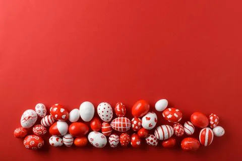 Easter backgrounds, scattered Easter red and white eggs on a bright red Stock Photos