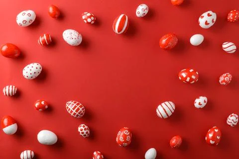 Easter backgrounds, scattered Easter red and white eggs on a bright red Stock Photos