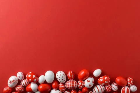 Easter backgrounds, scattered Easter red and white eggs on a bright red Stock Photos