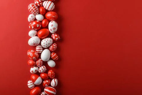Easter backgrounds, a strip of Easter red and white eggs on a bright red Stock Photos