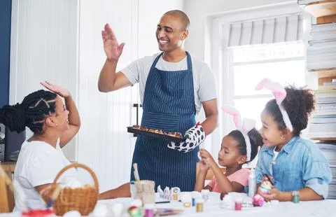 Easter, baking and high five with parents, kids and decoration for festive .. Stock Photos