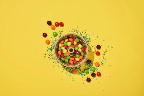 Easter baking background. Easter multicolored gingerbread, candy, scattered c Stock Photos