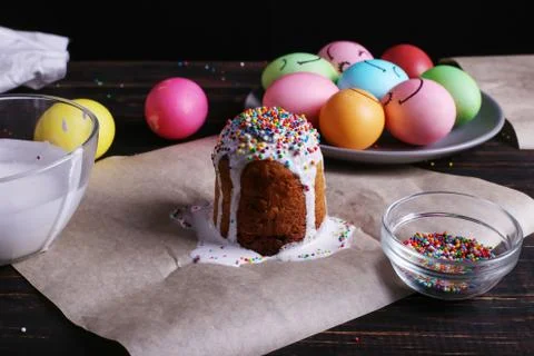 Easter baking with icing and colored powder and eggs. Preparing for the holid Stock Photos