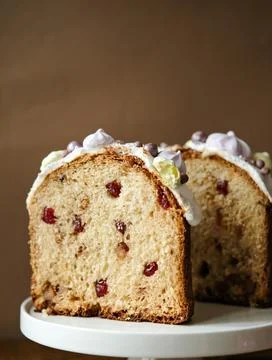 Easter baking. Kulich. Cake with raisins, candied oranges and dried cranberri Stock Photos
