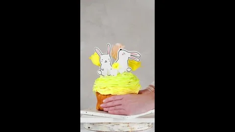Easter Baking with Paper Topiaries.Hands placing baked goods on a marble stand Stock Footage 302478435