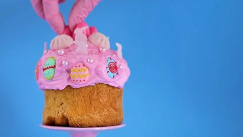 Easter baking.Easter cake on a pink ceramic stand on a blue background Stock Footage 297297274