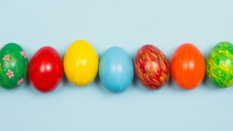 Easter banner background with handmade colored eggs on wooden a bright blue.. Stock Footage 232975106