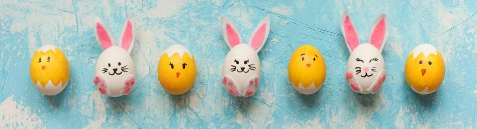 Easter banner with Easter eggs decorated as bunnies and chicks on blue Stock Photos