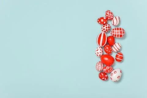 Easter banner with Easter red and white eggs on a light blue background. A pl Stock Photos