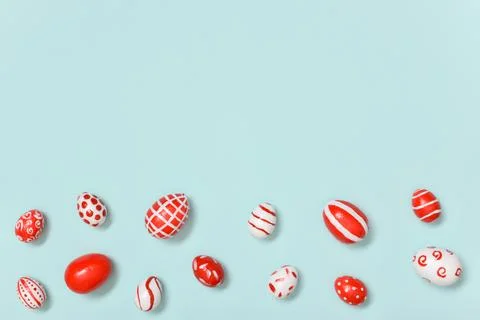 Easter banner with Easter red and white eggs on a light blue background. A pl Stock Photos