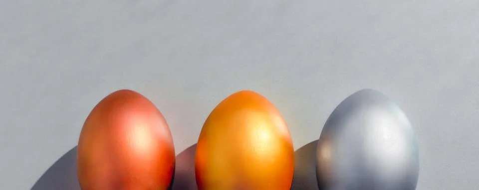 Easter banner egg set of three golden, silver and bronze decorated eggs Stock Photos