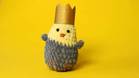 Easter banner. Knitted chicken from soft threads on a yellow background. Stock Footage 234747576