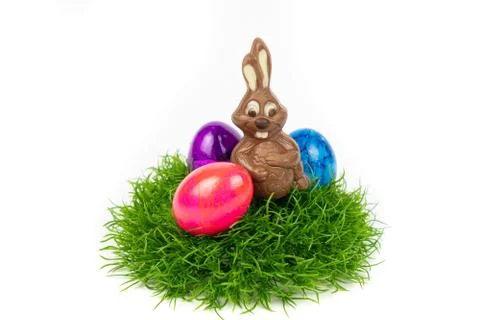 An Easter basket with chocolate Easter bunny and colorful Easter eggs isolate Stock Photos