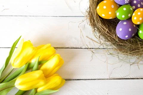 Easter basket with colored eggs Stock Photos