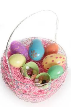 Easter basket with colorful easter eggs Stock Photos