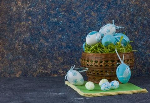 Easter basket with coloured Easter eggs on dark stone table Stock Photos