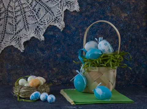Easter basket with coloured Easter eggs on dark stone table 写真素材