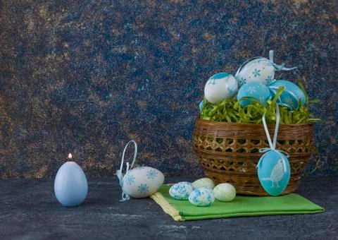 Easter basket with coloured Easter eggs on dark stone table 写真素材