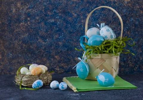 Easter basket with coloured Easter eggs on dark stone table 写真素材