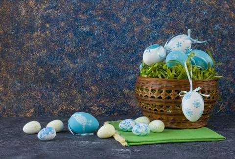 Easter basket with coloured Easter eggs on dark stone table Stock Photos
