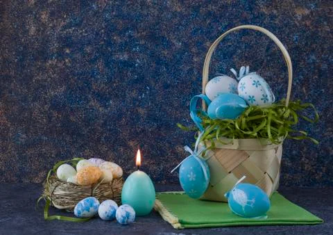 Easter basket with coloured Easter eggs on dark stone table Stock Photos