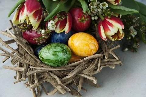 Easter basket with easter eggs and tulips Stock Photos