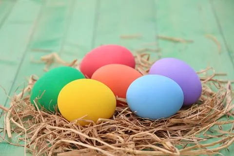 Easter basket with easter eggs on wooden background Stock Photos